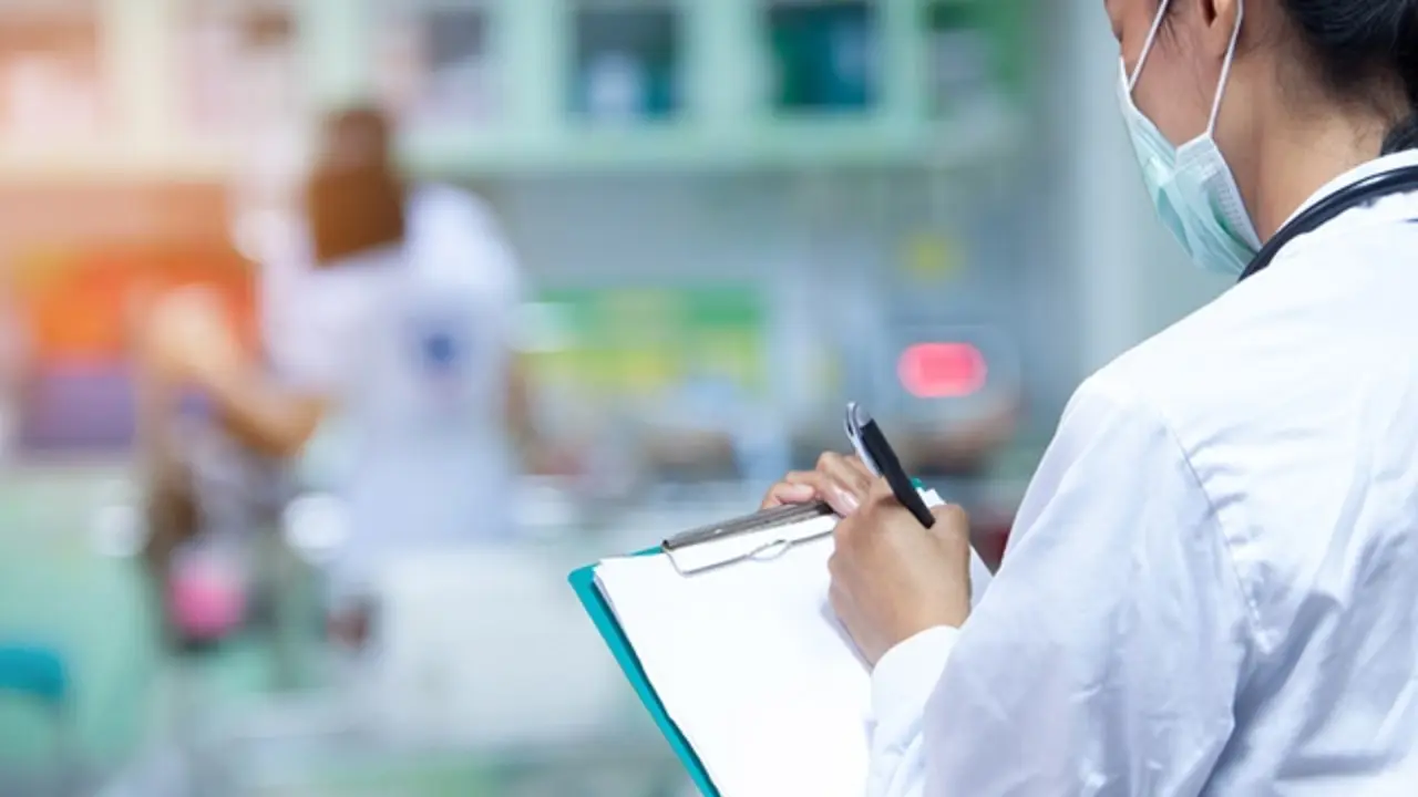 Doctor writing a medical prescription in hospital